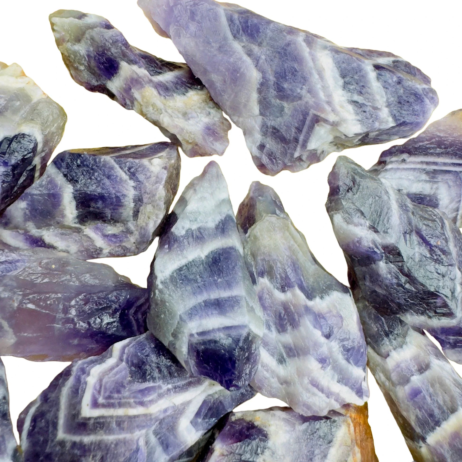 Held in hand, a single Chevron Amethyst raw stone sourced from Zambia.