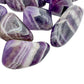Side perspective of Chevron Amethyst tumbled stone, often worked with for Intuition.