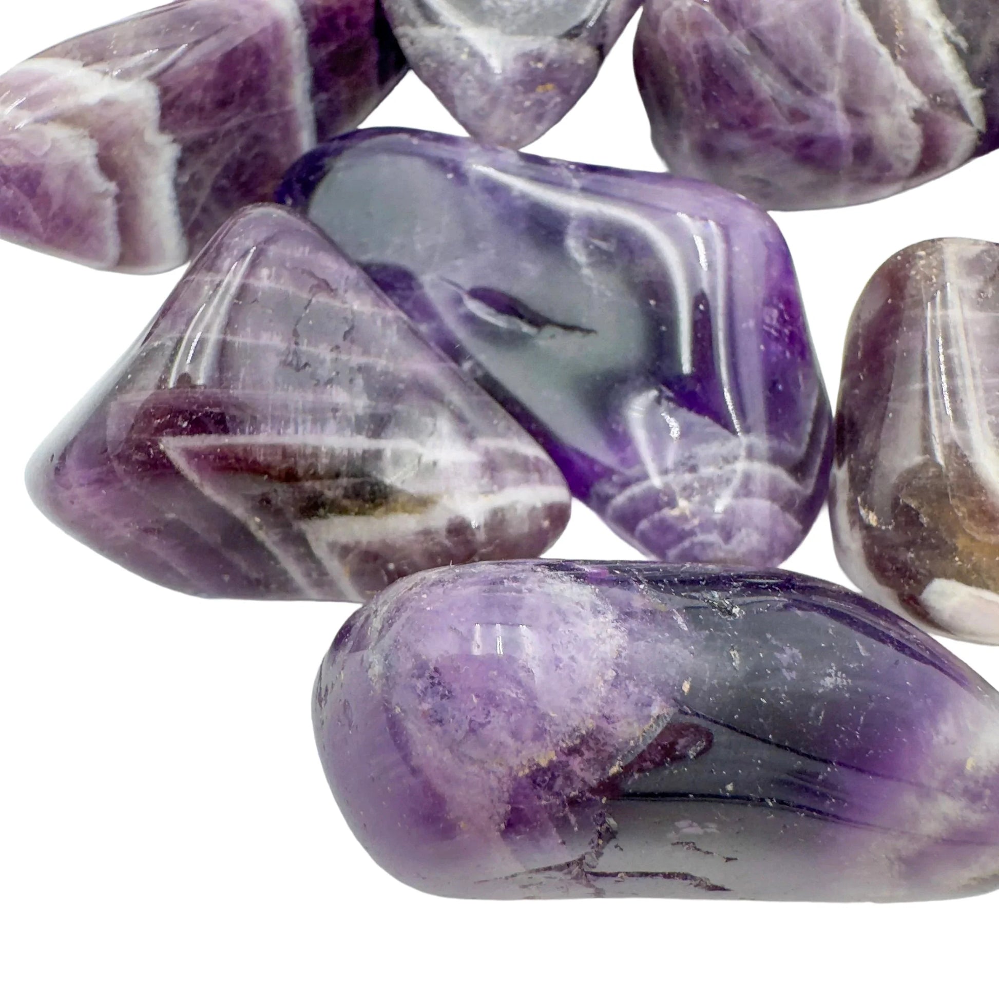 Overhead view of Chevron Amethyst tumbled stone, showing characteristic finish, sourced from Zambia.