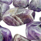 In-hand view of a Chevron Amethyst tumbled stone for Intuition, Zambia-sourced.