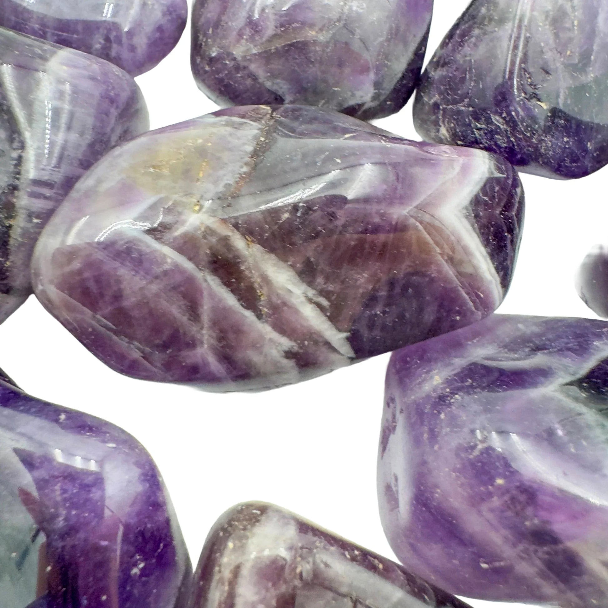 In-hand view of a Chevron Amethyst tumbled stone for Intuition, Zambia-sourced.