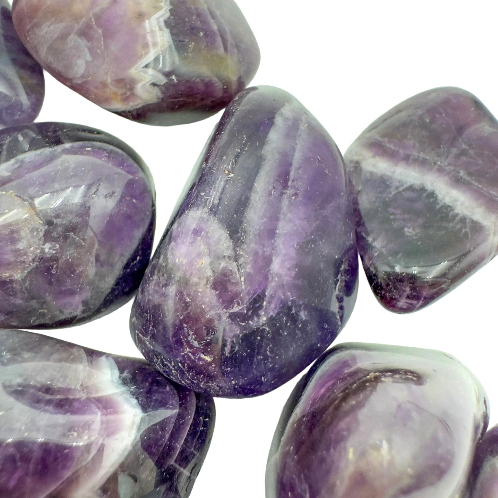 Hand-scale view of Chevron Amethyst tumbled stone, from Copperbelt Province, Zambia, associated with Meditation, shown for proportion against the hand.