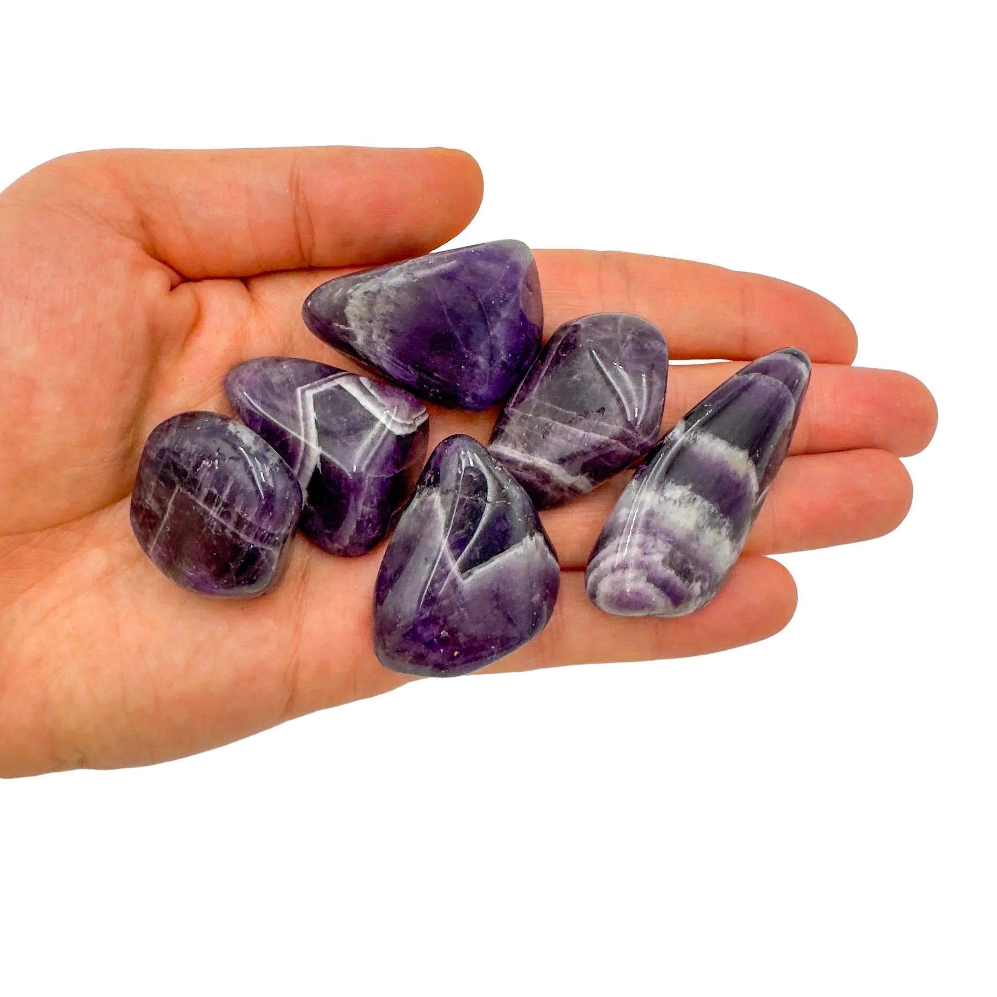 Detail shot of Grade AA Chevron Amethyst tumbled stone under natural light