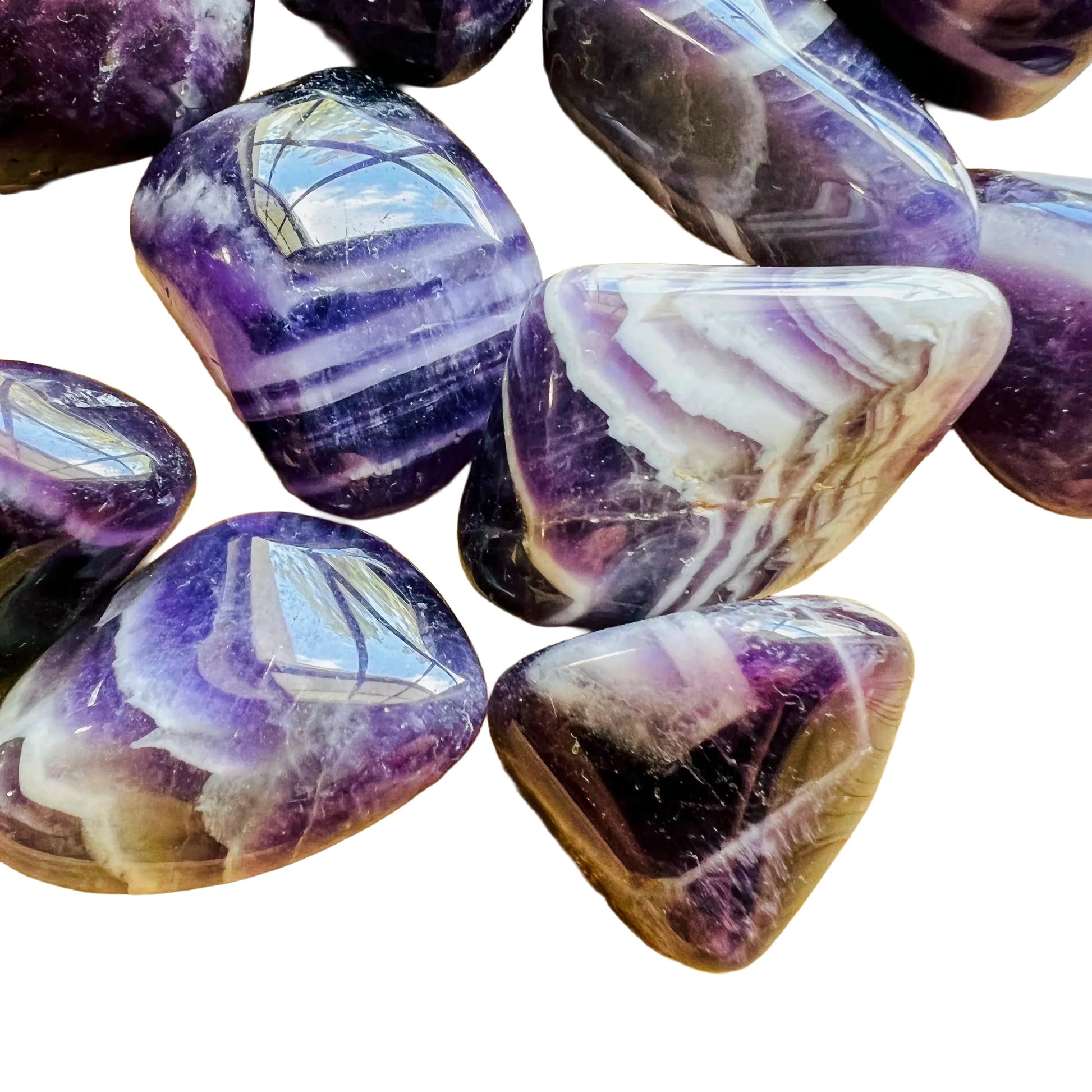 Overhead angle of purple Chevron Amethyst tumbled stone, showing soft luster, worked with for Intuition.