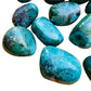 Top-down shot of Chrysocolla tumbled stone, showing earthy tone, sourced from Arequipa, Peru.