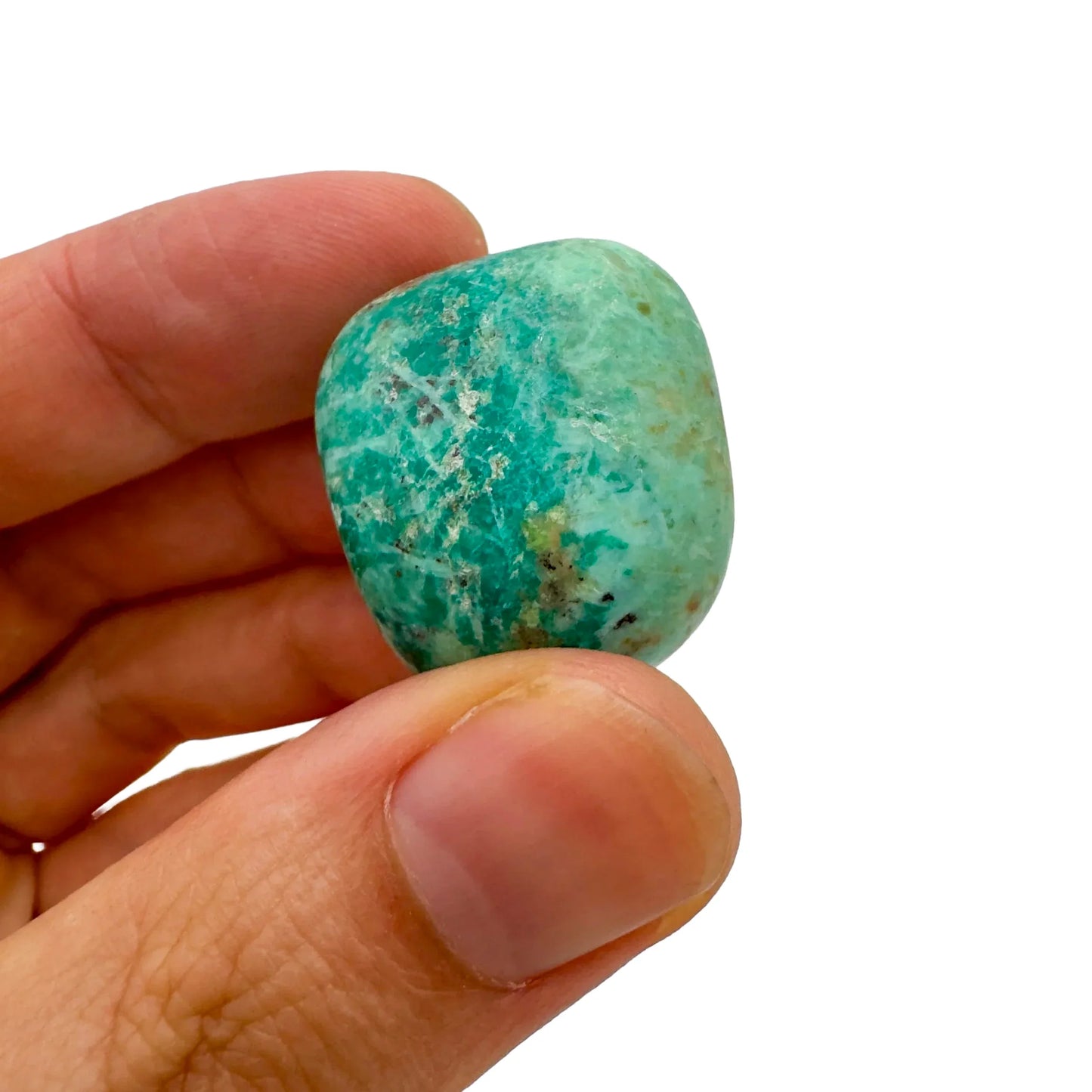 Lifestyle view of a Chrysocolla tumbled stone to support Emotional Healing, sourced from Arequipa, Peru.