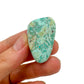 Lifestyle still of Chrysocolla tumbled stone, often kept for Emotional Healing, with character of the piece on display.