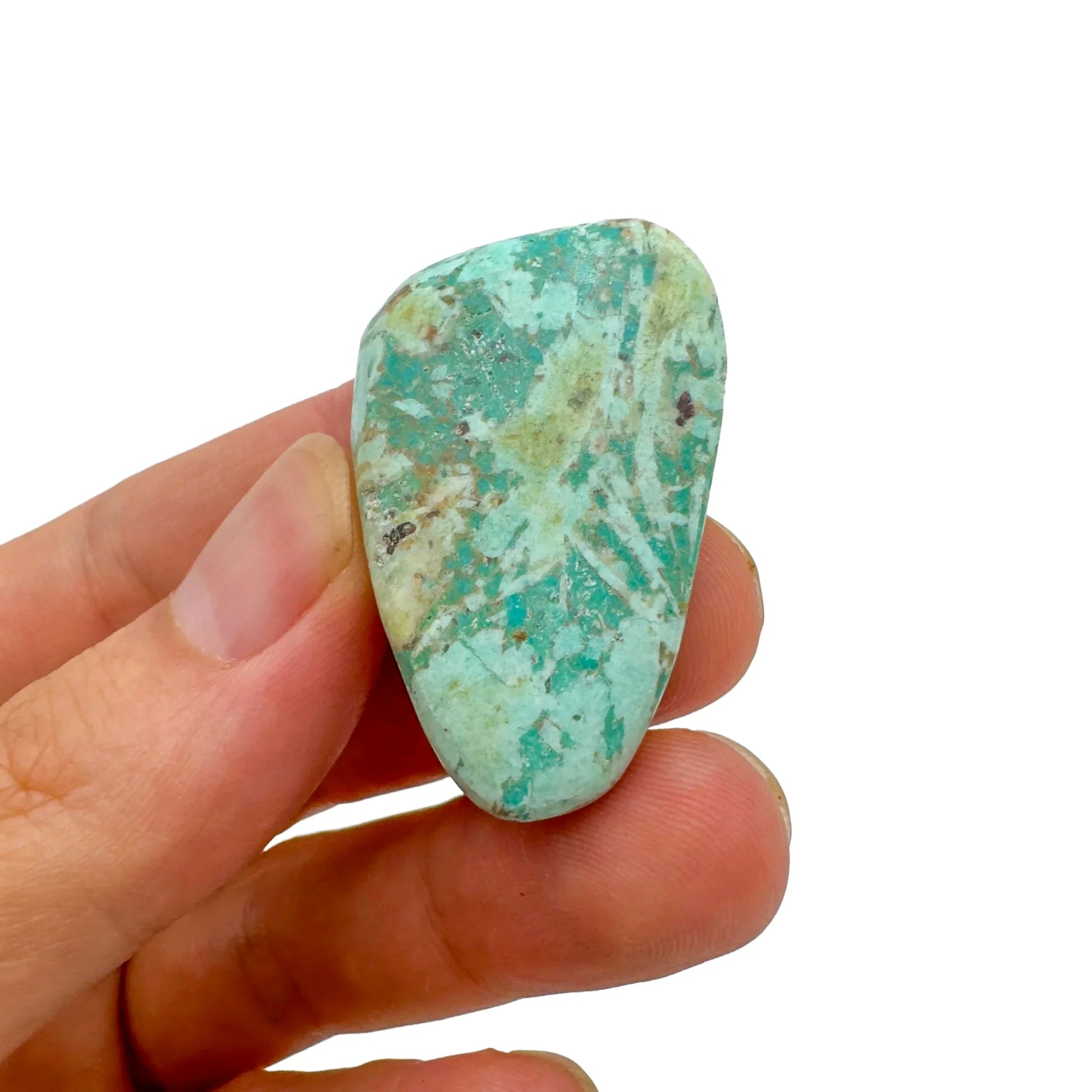 Lifestyle still of Chrysocolla tumbled stone, often kept for Emotional Healing, with character of the piece on display.