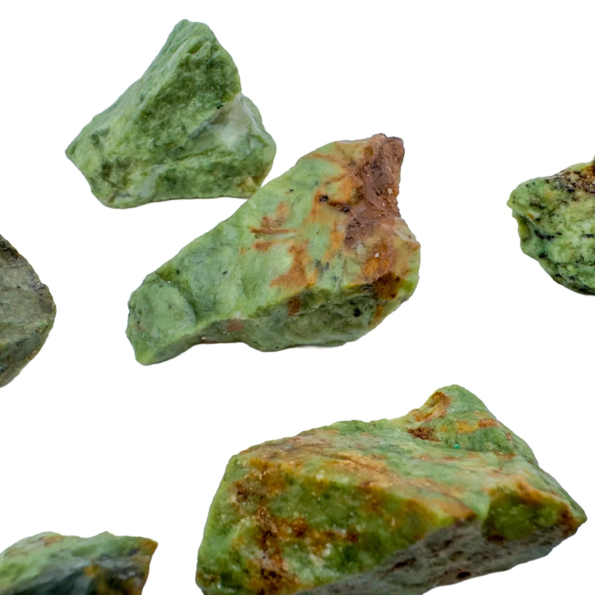 On a soft surface rests a Chrysoprase raw crystal, captured against a quiet backdrop.