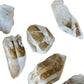 Looking down on Grade AA Clear Quartz raw point, showing characteristic finish, often worked with for Cleansing.