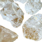 Detail shot showing Clear Quartz raw stone, sourced from Brazil, kept close for Cleansing and Meditation.