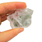 In-hand view of a single Clear Quartz raw stone sourced from Brazil.