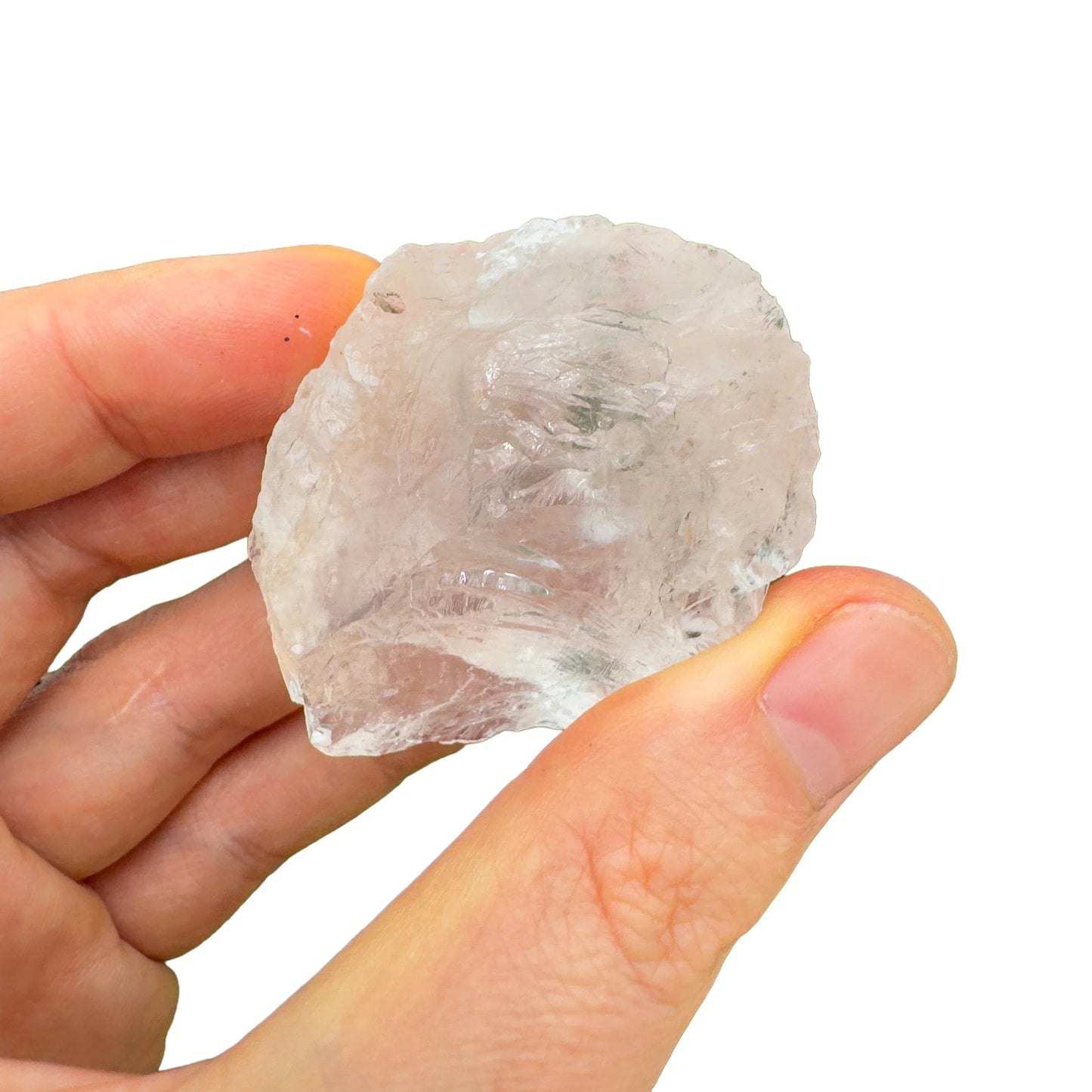 Held in hand is a Clear Quartz raw crystal, from Minas Gerais, Brazil, traditionally used for Manifestation, shown for proportion against the hand.