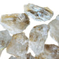 Detail shot showing Clear Quartz raw stone, hand-selected from Minas Gerais, Brazil, showing natural texture.