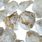 Overhead view of Grade AA Clear Quartz raw stone, often kept for Cleansing, showing open form.