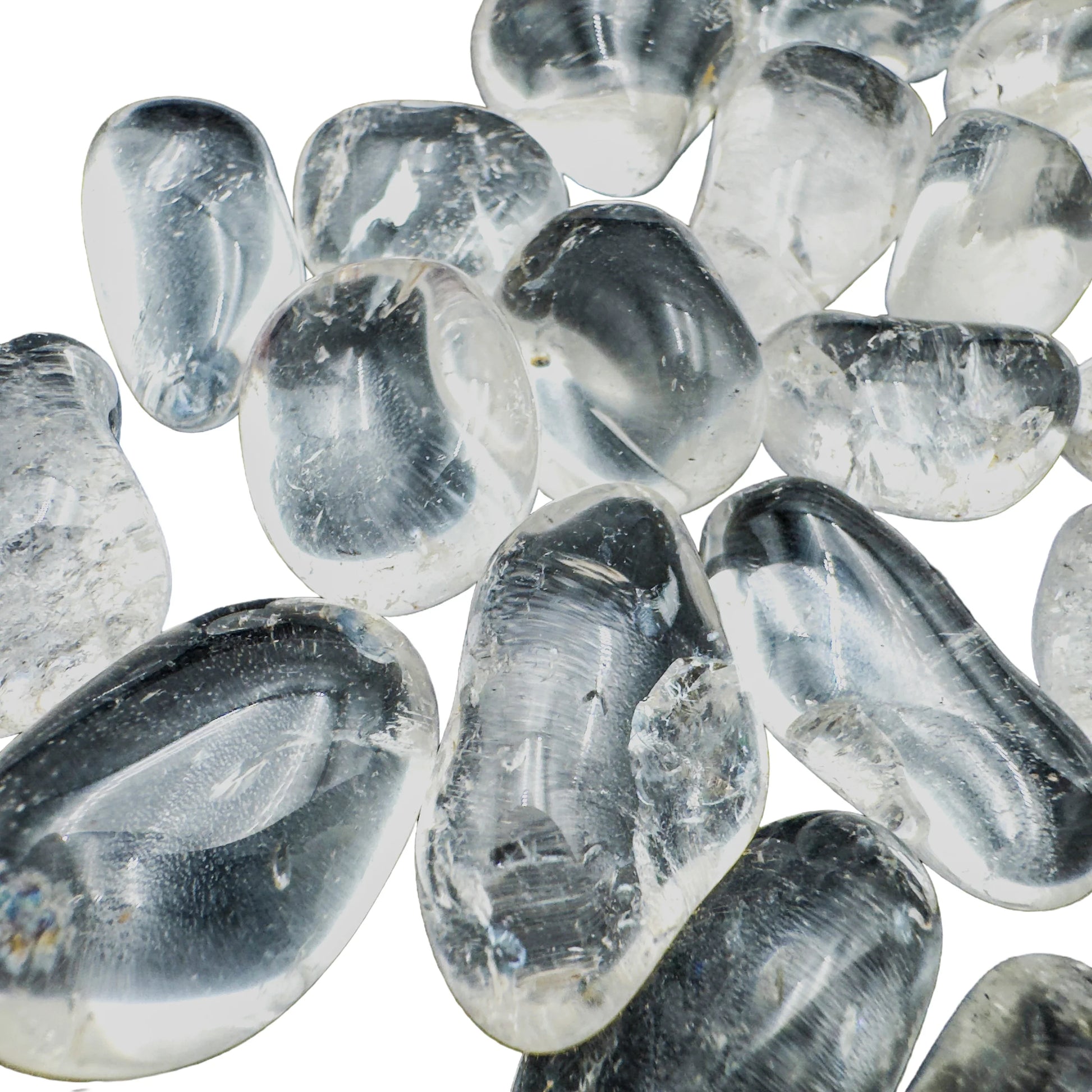 Close-up of polished Clear Quartz tumbled stones showing crystalline depth and natural inclusions, AAA grade Brazil