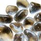 Top-down shot of Clear Quartz tumbled stone, hand-selected from Minas Gerais, Brazil, showing matte finish.