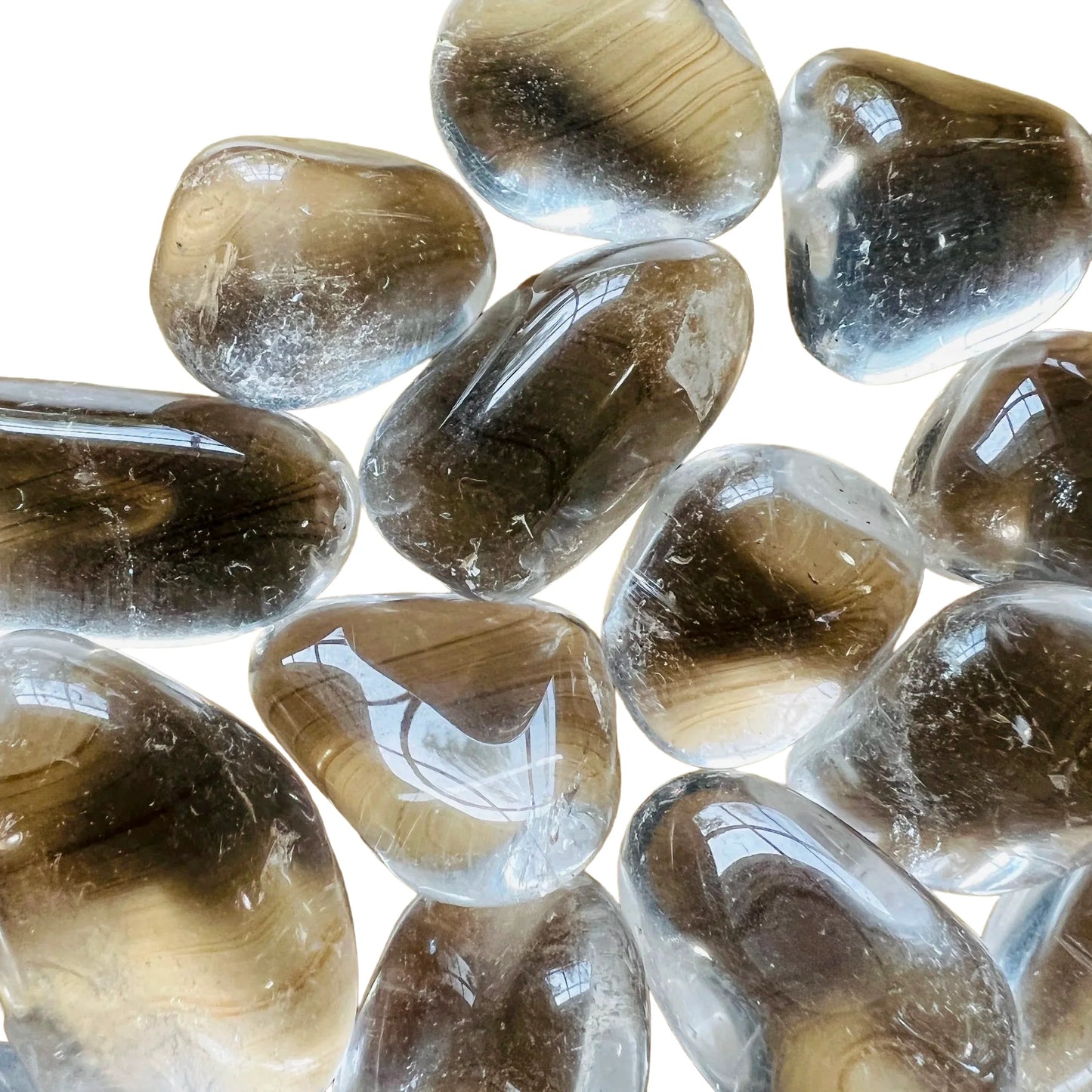 Top-down shot of Clear Quartz tumbled stone, hand-selected from Minas Gerais, Brazil, showing matte finish.