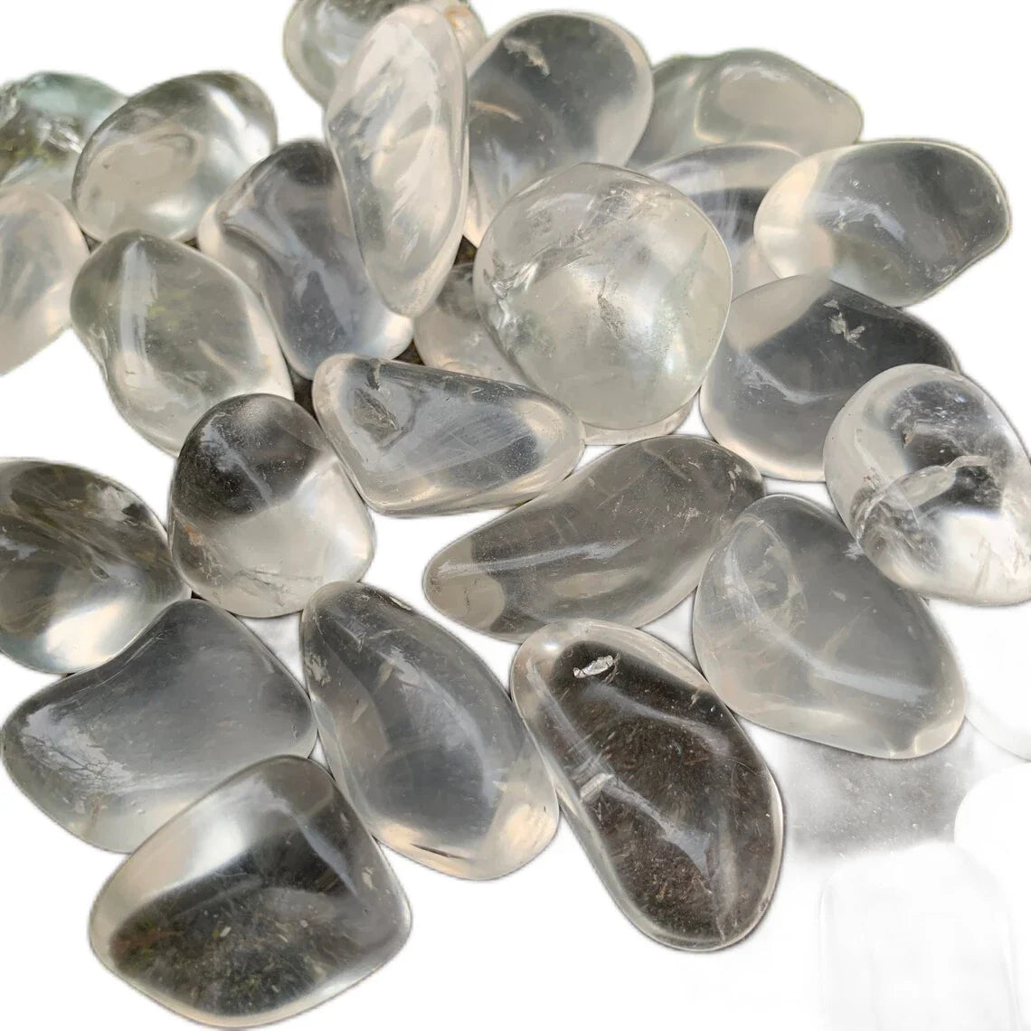 Composed shot of Clear Quartz tumbled stone, linked to Manifestation, with surface texture in view.
