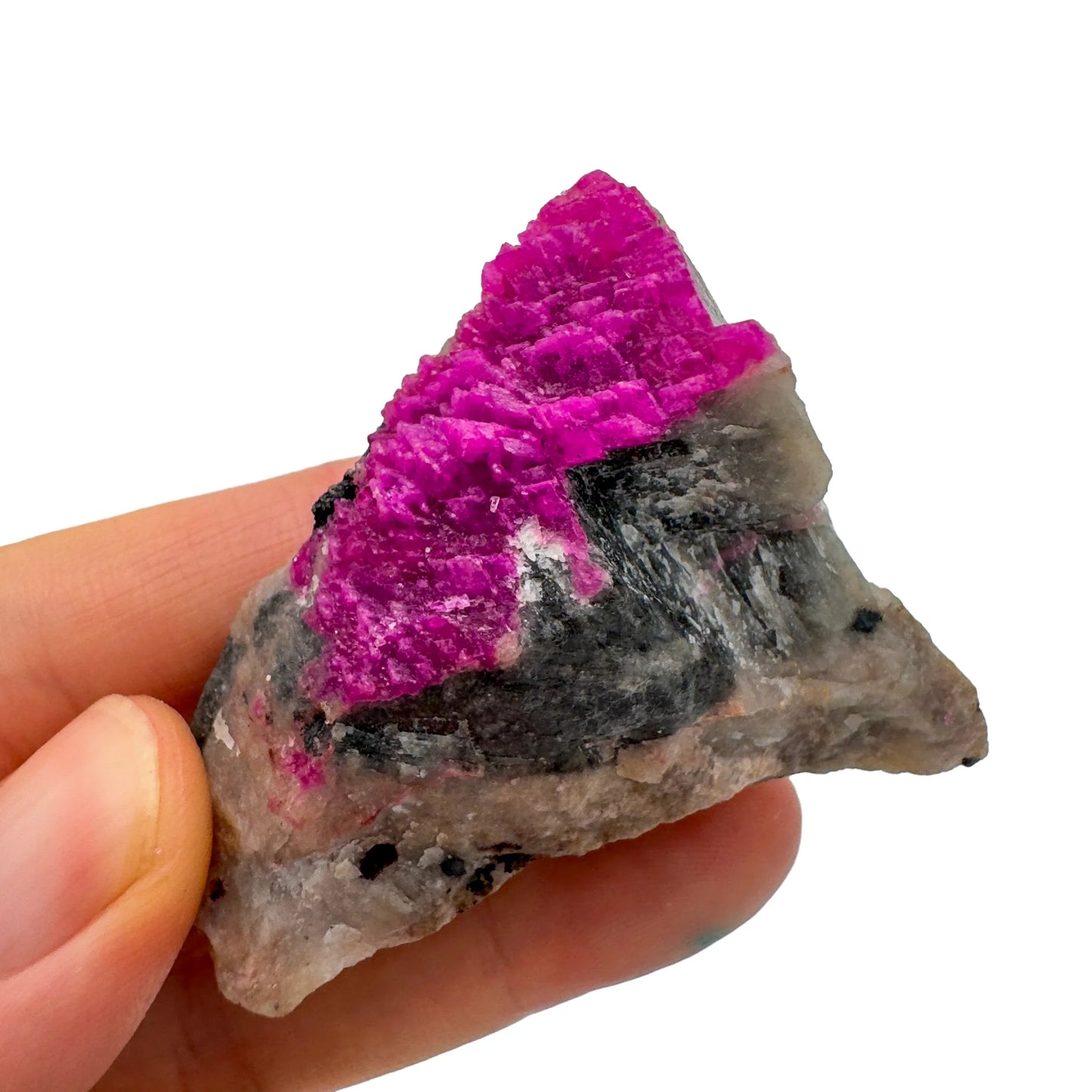 In context of a Cobalt Calcite raw crystal, with surface texture in view.