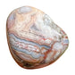 Near view of Crazy Lace Agate tumbled stone, sourced from Mexico, showing glassy finish.