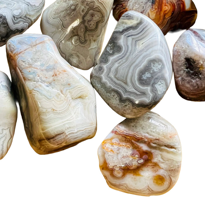 Close-up of Grade A Crazy Lace Agate tumbled stone, showing translucent edges, sourced from Mexico.