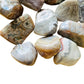 Sideways view of Crazy Lace Agate tumbled stone, showing subtle veining, sourced from Mexico.