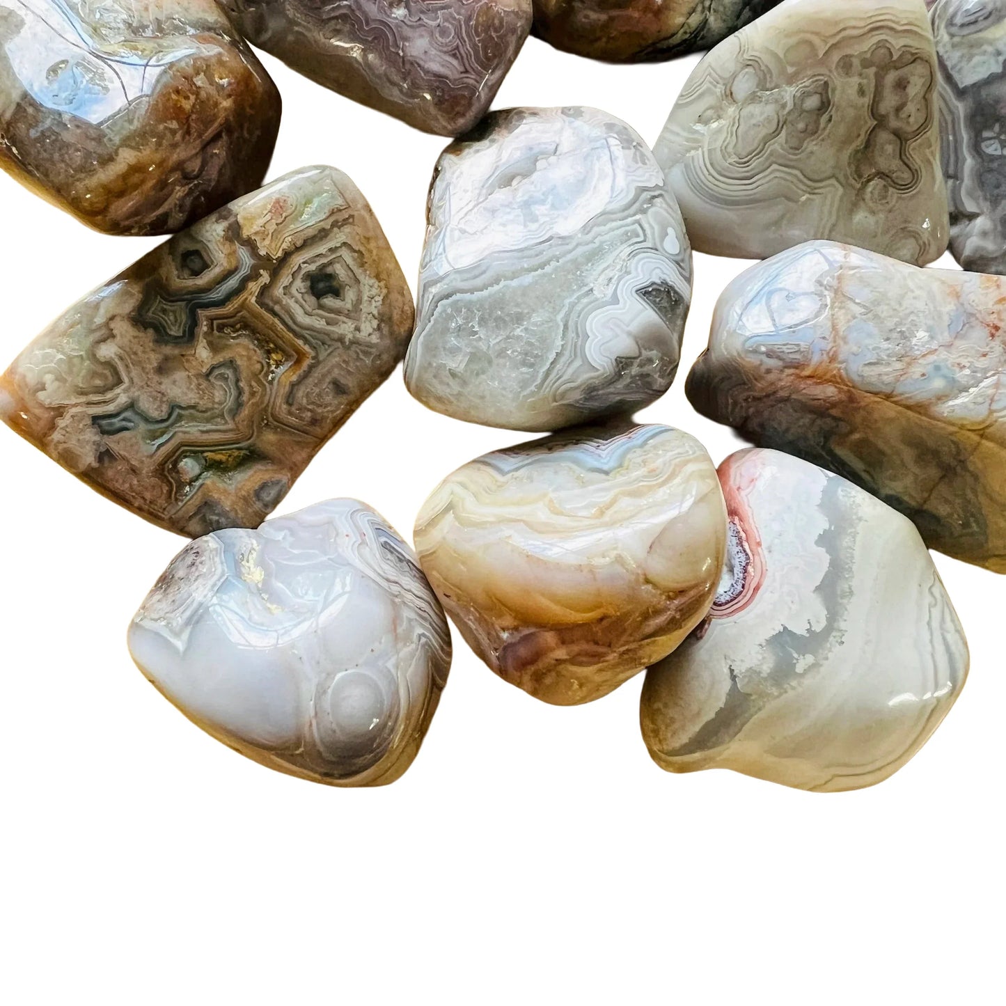 Sideways view of Crazy Lace Agate tumbled stone, showing subtle veining, sourced from Mexico.