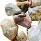 Bird's-eye view of Crazy Lace Agate tumbled stone, often kept for Energy, Mexico-sourced.