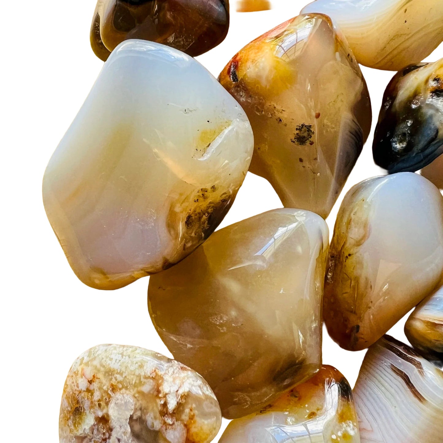 Plan view of Dendritic Agate tumbled stone, showing earthy tone, turned to for Grounding.