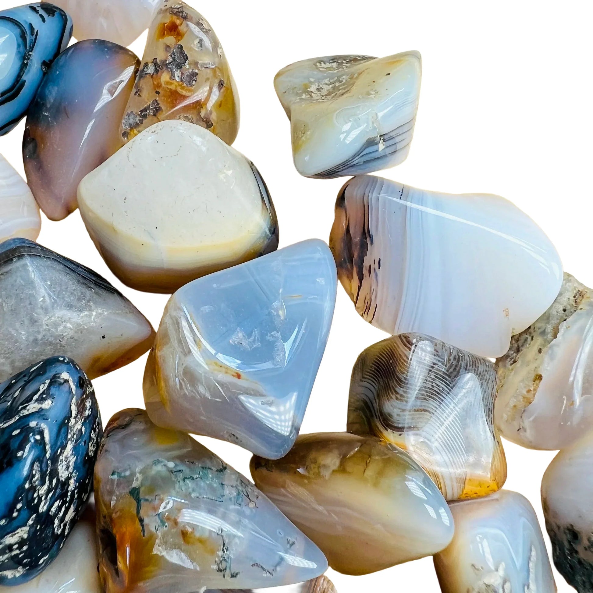 Profile shot of Dendritic Agate tumbled stone, showing natural variation, linked to Grounding.