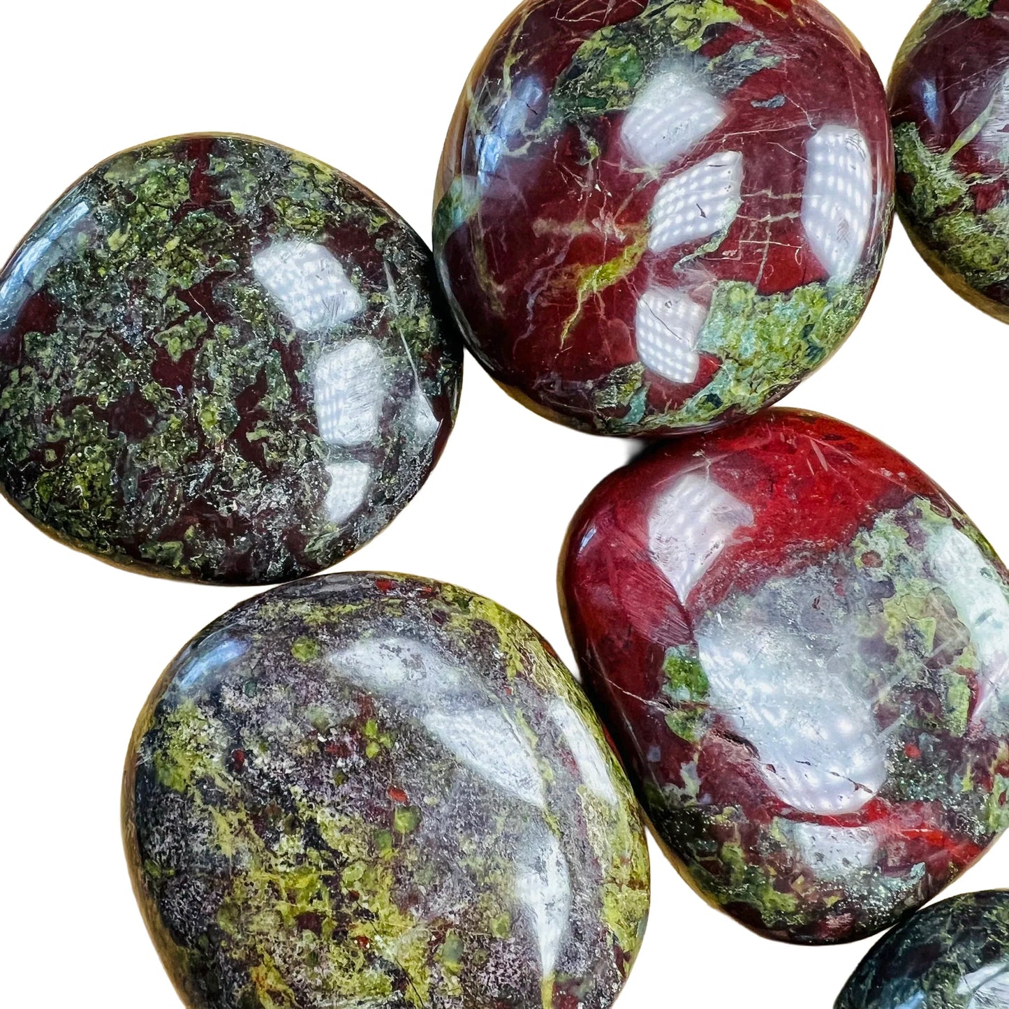 Edge view of green Dragon Bloodstone palm stone, hand-selected from Limpopo, South Africa, worked with for Confidence.