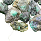 Worktop view of Emerald raw crystal, from Bahia, Brazil, often kept for Love, showing natural surface character.