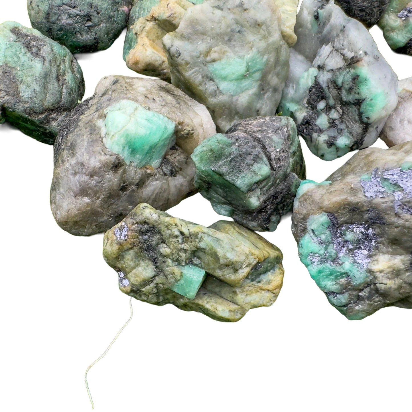 Worktop view of Emerald raw crystal, from Bahia, Brazil, often kept for Love, showing natural surface character.