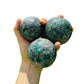 Profile shot of Emerald polished sphere, showing natural texture, drawn on for Love and Abundance.