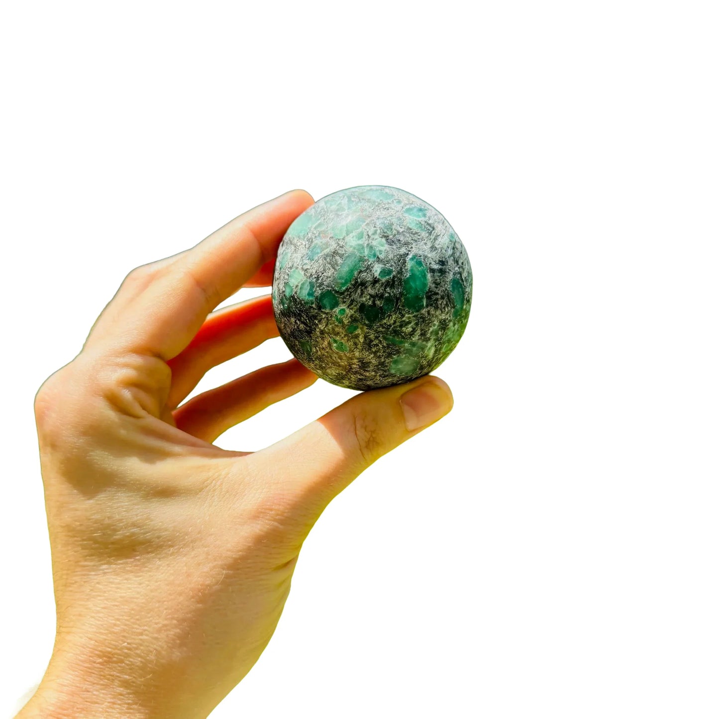 Natural light view of a Emerald polished sphere kept close for Love.