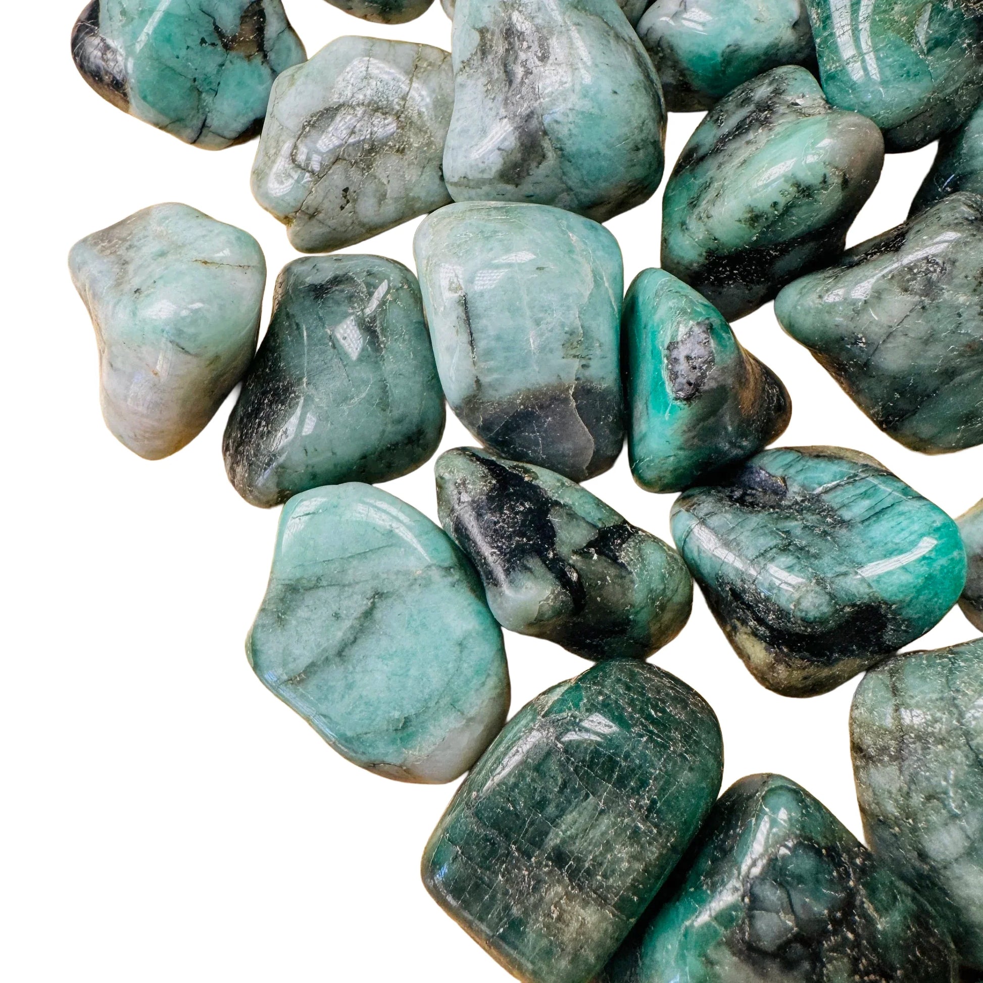 Detail shot of Grade AA Emerald tumbled stone under natural light