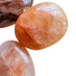 Top-side view of Fire Quartz palm stone, to support Grounding and Confidence.