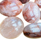 Size comparison with one Fire Quartz palm stone for scale, sourced from Madagascar.