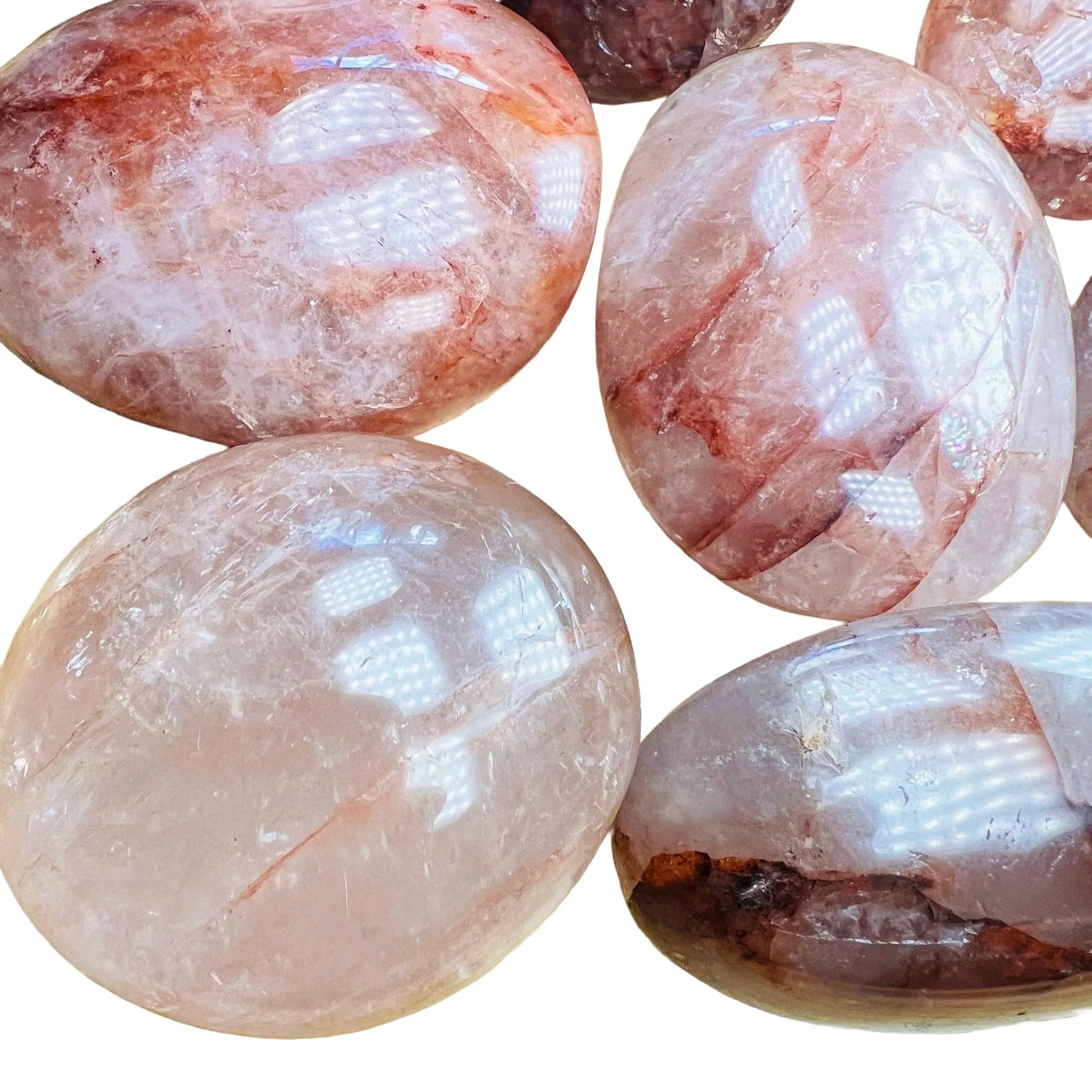 Size comparison with one Fire Quartz palm stone for scale, sourced from Madagascar.