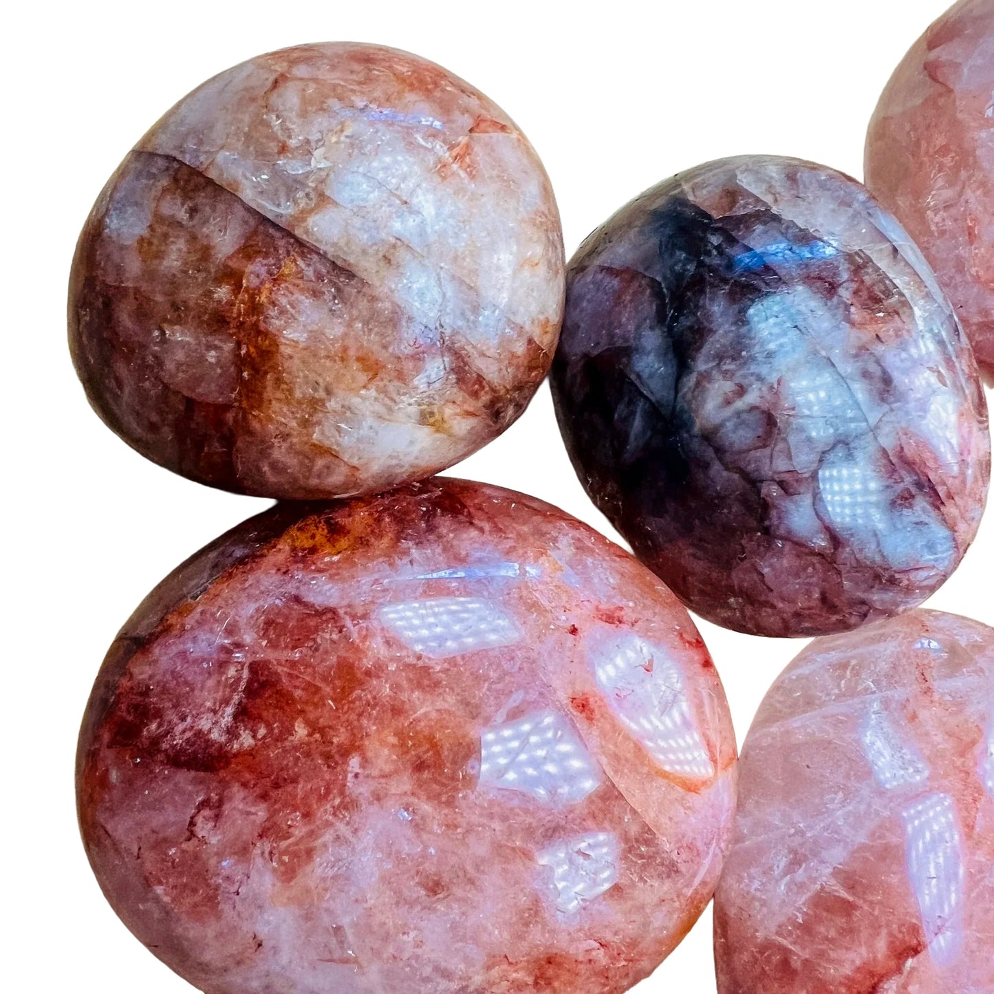 Three-quarter view of Fire Quartz palm stone, captured against a quiet backdrop.