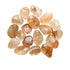 Detail shot of Grade AA Fire Quartz tumbled stone under natural light
