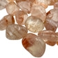 Edge view of Fire Quartz tumbled stone, kept near for Grounding, from Madagascar.