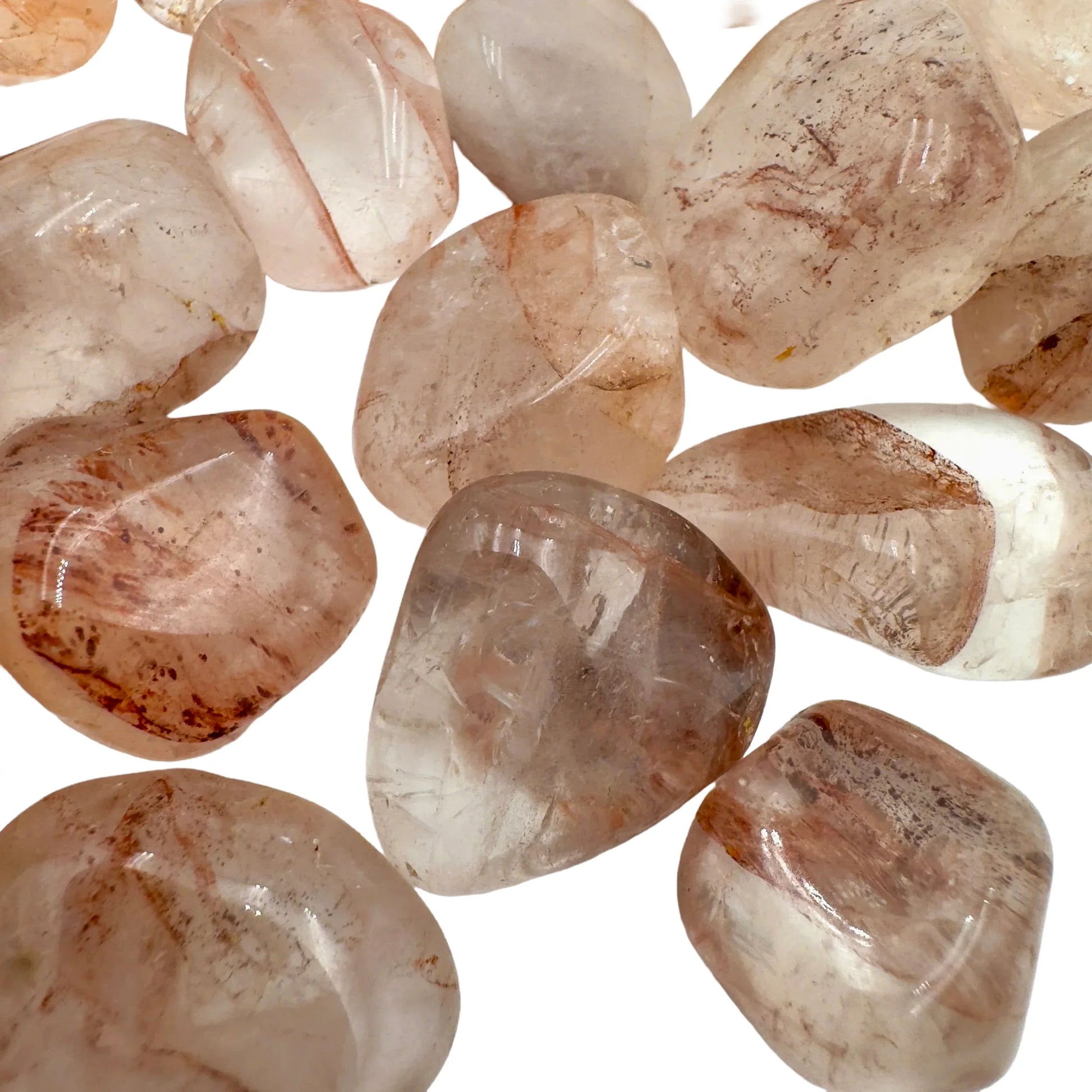 Bird's-eye view of red Fire Quartz tumbled stone, showing soft luster, Madagascar-sourced.