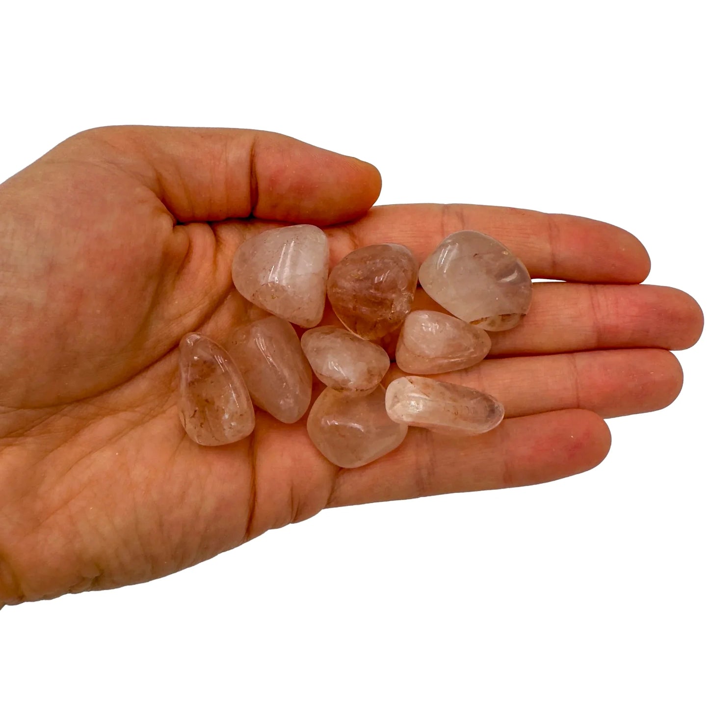 Palm-scale view of a single Fire Quartz tumbled stone hand-selected from Alaotra-Mangoro, Madagascar.