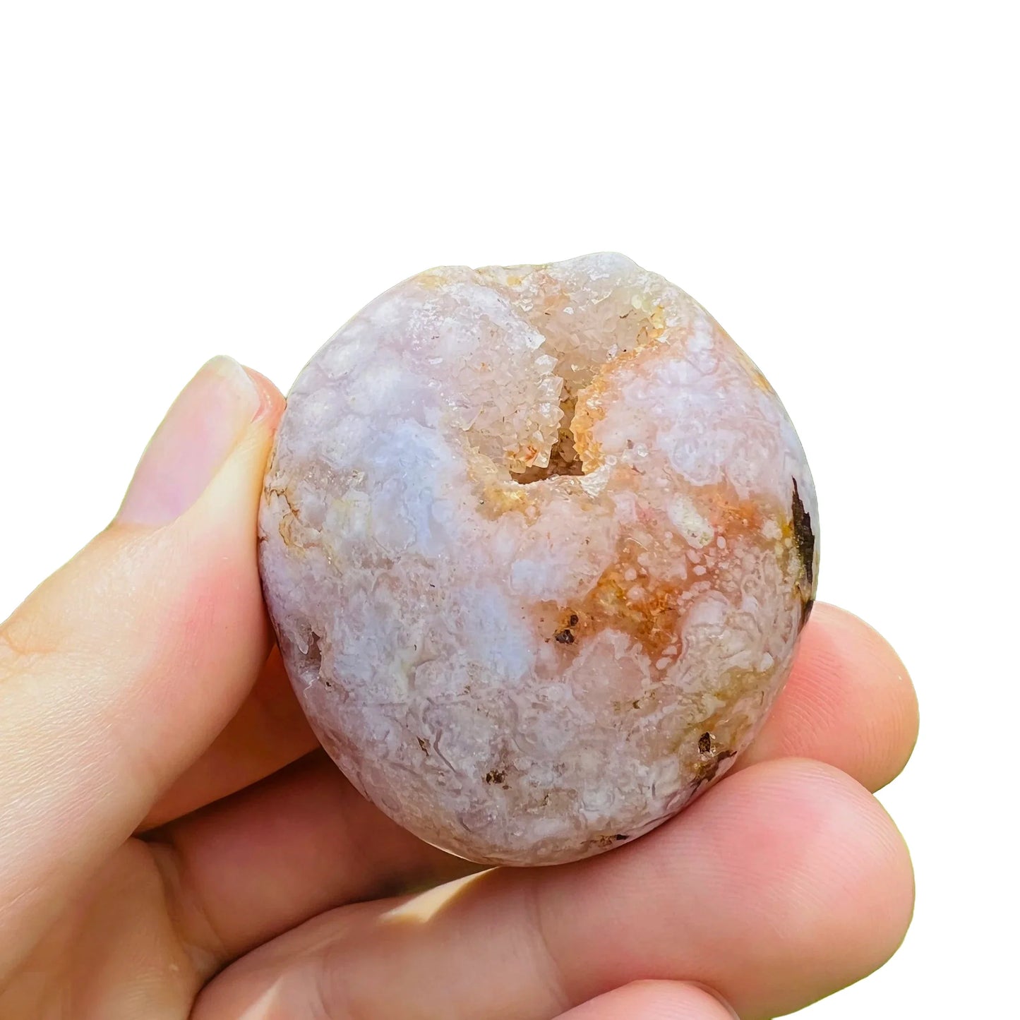 Hand-scale view of Flower Agate palm stone, from Boeny, Madagascar, shown at hand scale.