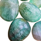 Close-up of Fluorite palm stone, showing color depth, Madagascar-sourced.