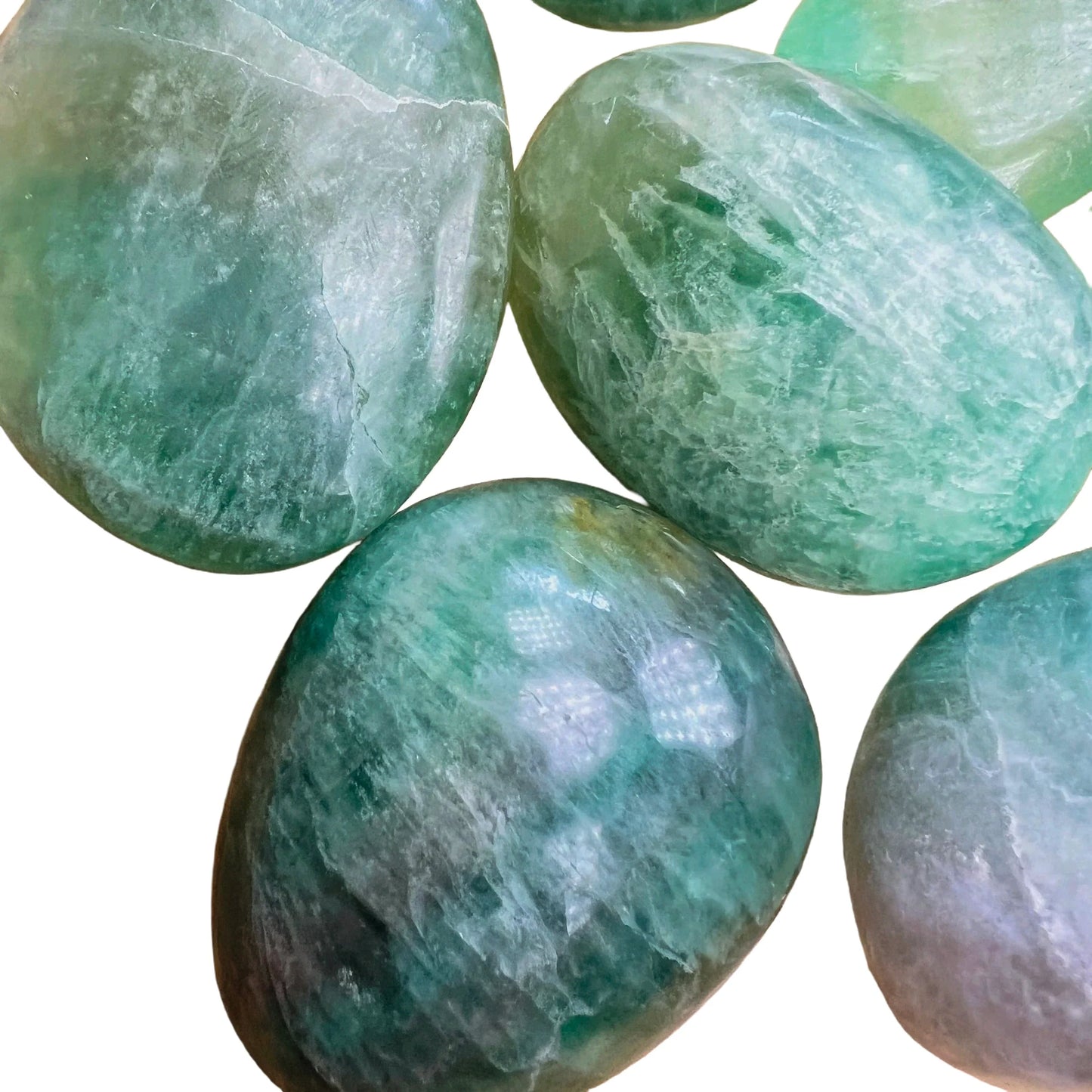 Close-up of Fluorite palm stone, showing color depth, Madagascar-sourced.