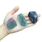 Grade aa fluorite raw held in hand for size reference