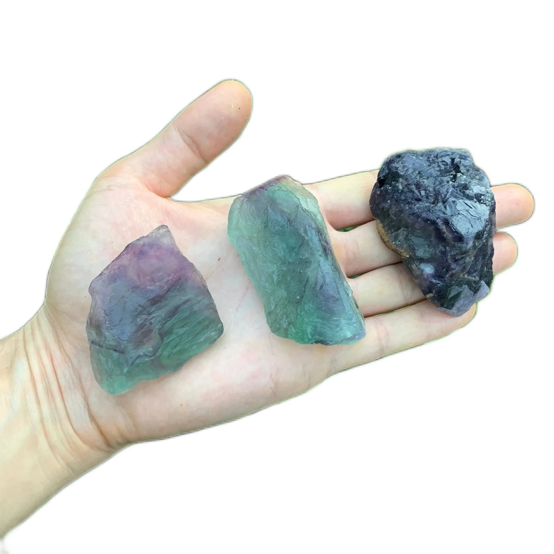 Grade aa fluorite raw held in hand for size reference